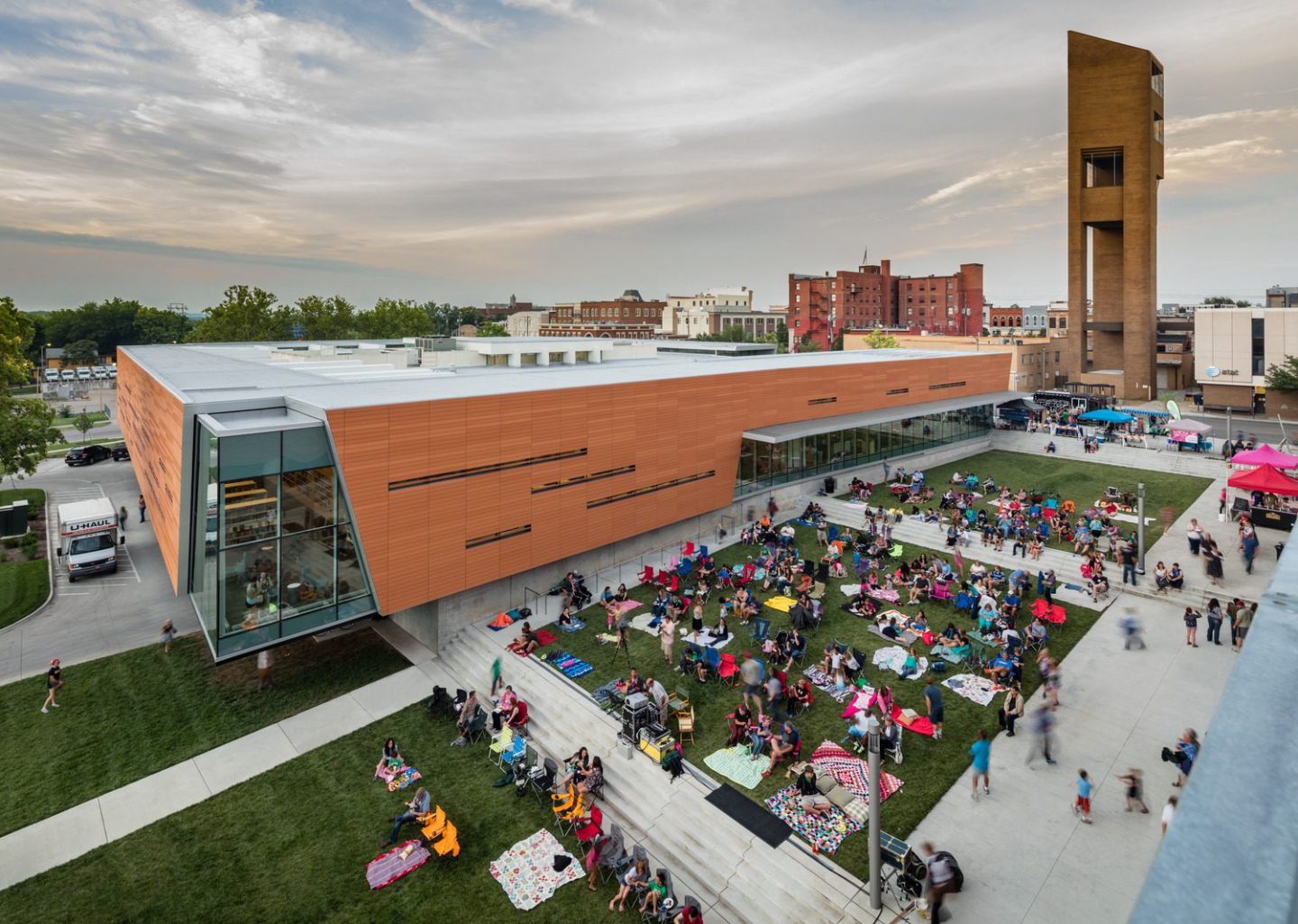 Aerial view of Lawrence Public Library with large crowd occupying public plaze
