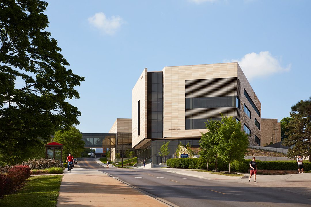 Image of corner exterior of KU Earth, Energy & Environment Center during the daytime with students walking on campus