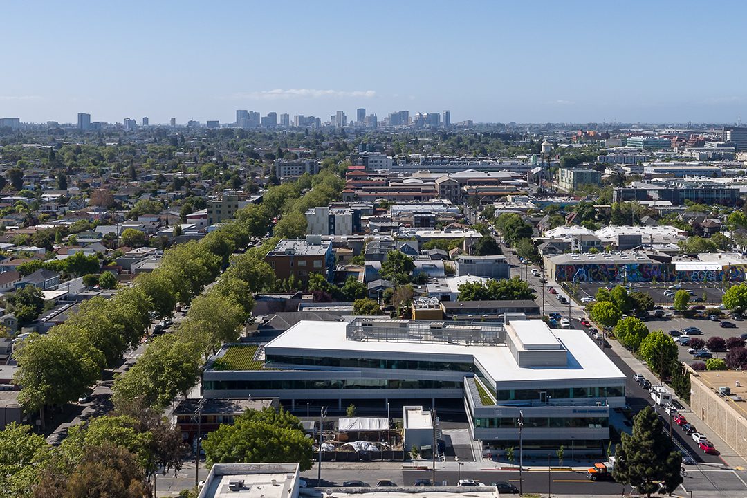 Aerial image of the Kaiser Permanente Berkeley Medical Office Building and surrounding neighborhood context looking towards downtown Oakland