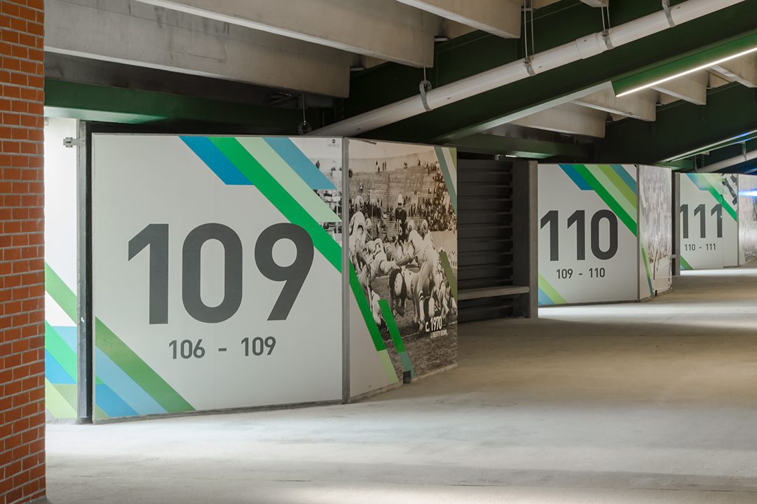 Image of Yulman Stadium's concourse graphics that feature the university's historical football imagery