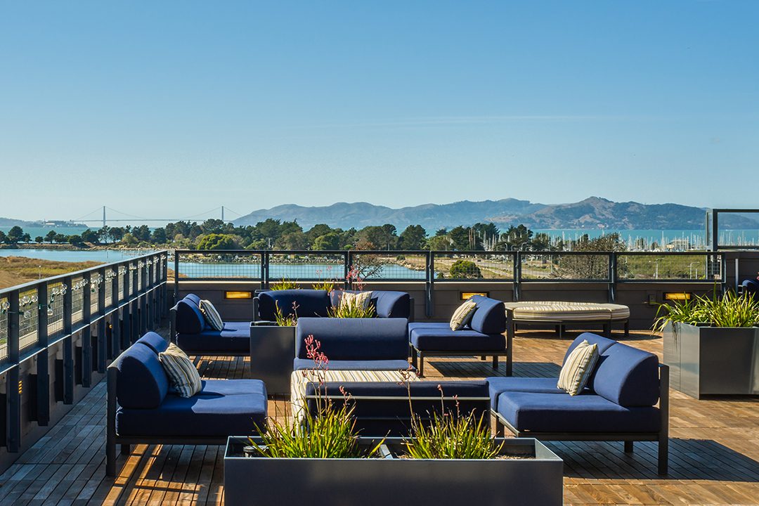 Image of the rooftop patio of Avalon Berkeley with the bay, Golden Gate Bridge, and Marin County as the view.